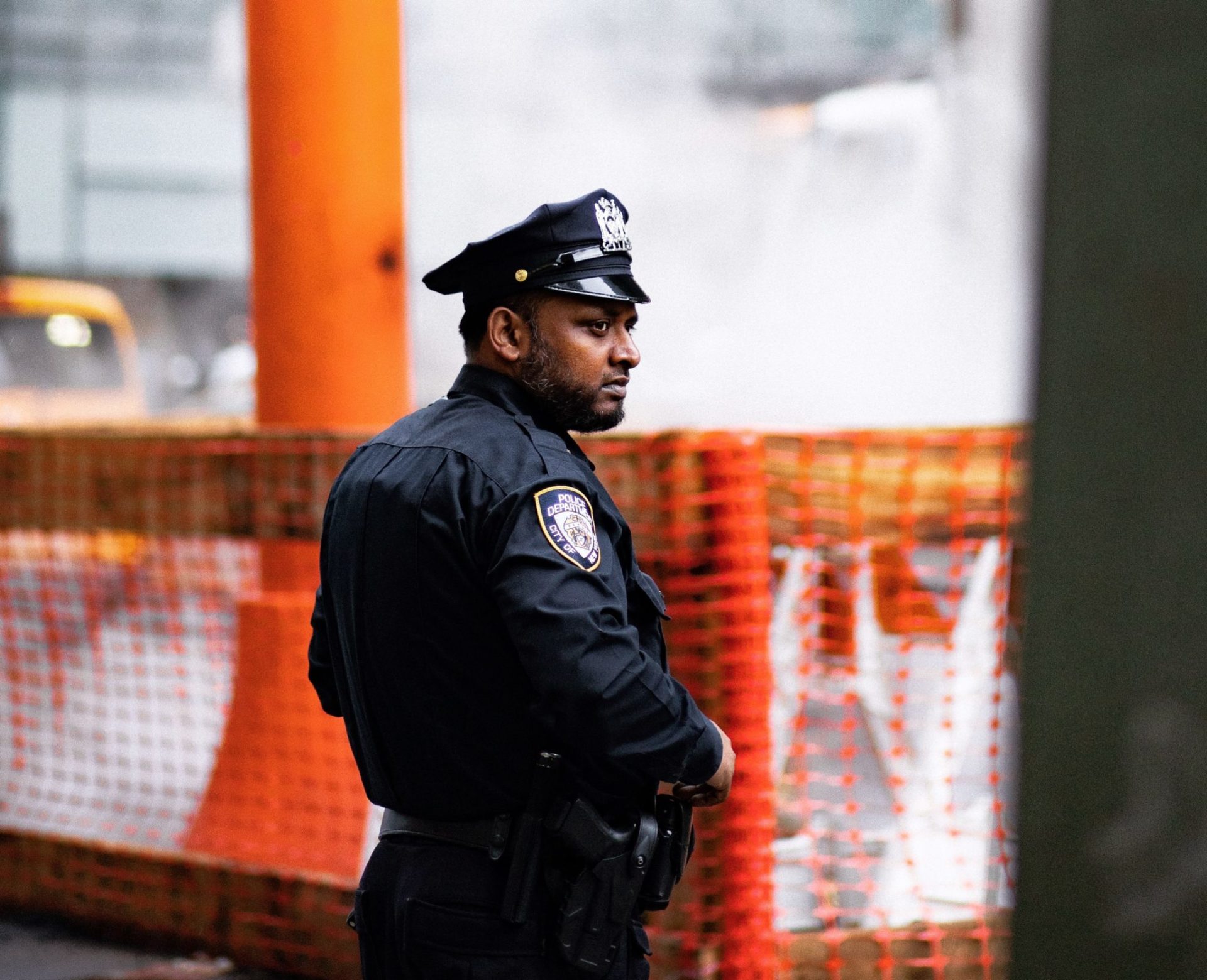 Police officer in city with construction